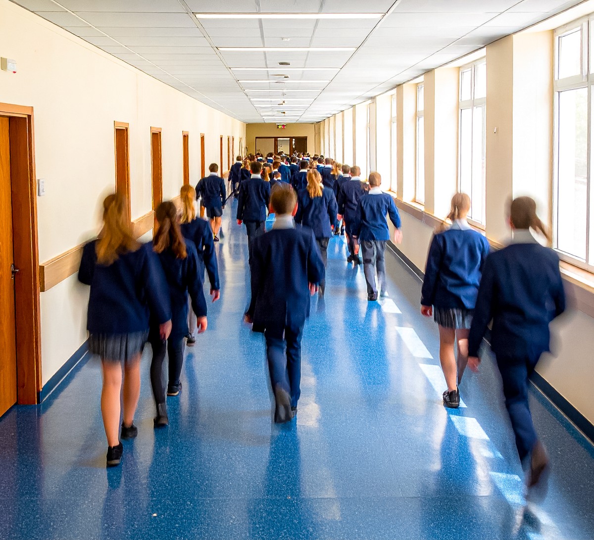 Pupils moving through a school corridor