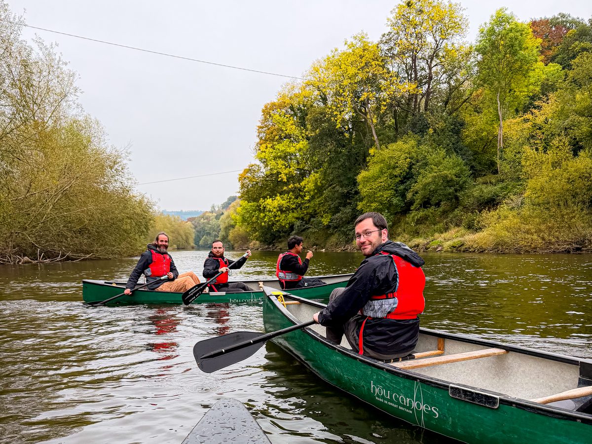 The GroupEd team canoeing together in life jackets
